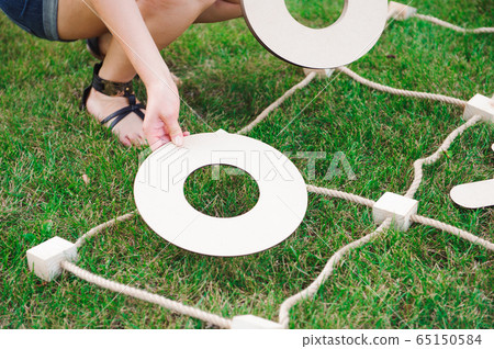 Big Tic Tac Toe game. Guy and girl playing outdoors. Big Tic Tac Toe game. Guy and girl playing outdoors. 65150584