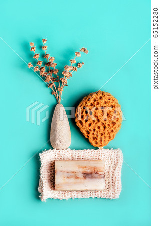 Natural spa and skincare beauty cleansing products with bathroom accessories including natural sponge, pumice stone and exfoliating soap with dry herbs. 65152280