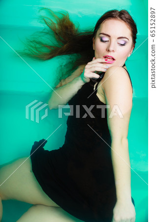 Sexual posing woman in water. 65152897