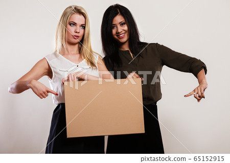two women with blank board two women with blank board 65152915
