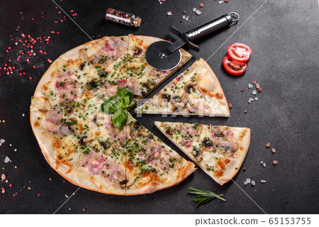 Fresh hot pizza with bacon, onions  and greens 65153755