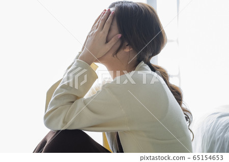 Depressed woman sitting on the floor Depressed woman sitting on the floor 65154653