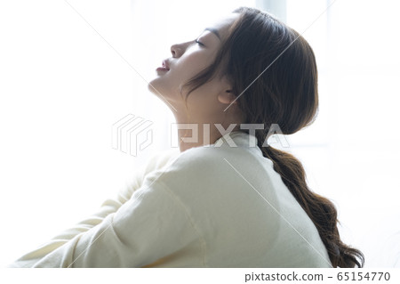Depressed woman sitting on the floor Depressed woman sitting on the floor 65154770