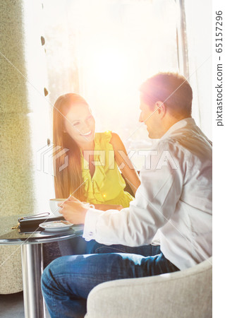 Businessman sitting while discussing plans with 65157296