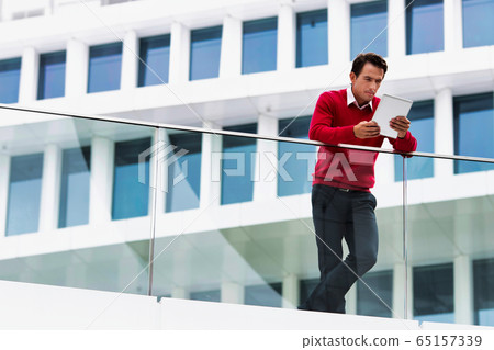 Young attractive businessman using digital tablet 65157339