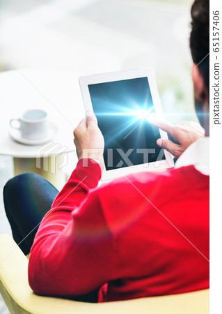 Portrait of attractive businessman using digital 65157406