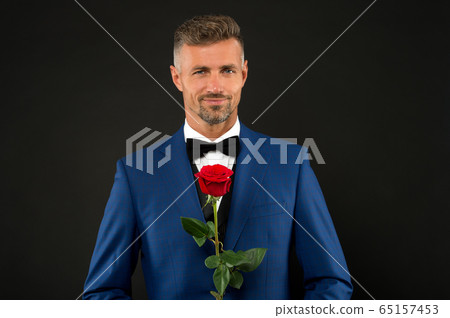 Lovely face of male. groom in tuxedo with rose. Lovely face of male. groom in tuxedo with rose. 65157453