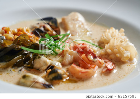 Plate with different seafood on table. 65157593