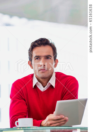 Portrait of attractive businessman using digital 65161638
