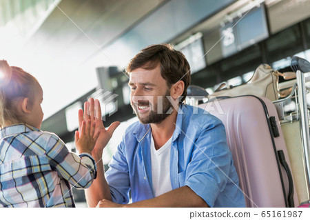 Man talking to his daughter and giving her a high Man talking to his daughter and giving her a high 65161987