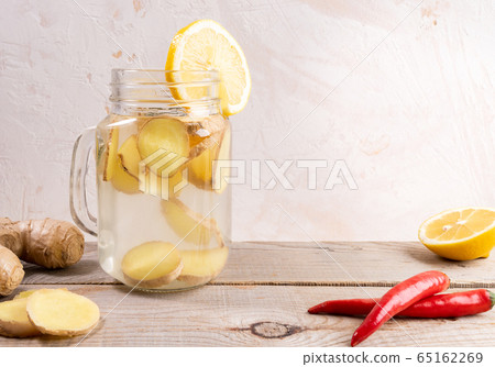 Glass jar full with ginger water and spises on 65162269