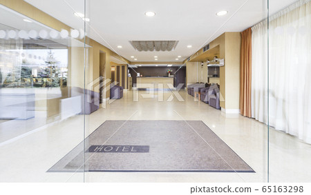 Open glass door at entrance of modern hotel 65163298