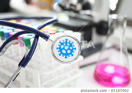 Medical stethoscope lying on set of vials at scientific lab Medical stethoscope lying on set of vials at scientific lab 65165002