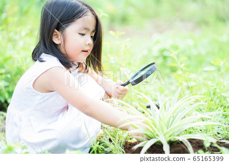 A child playing in the garden A child playing in the garden 65165399