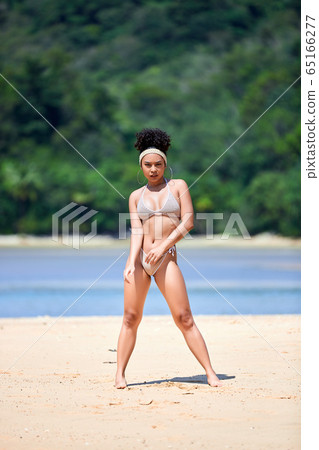 Young asian girl in bikini dancing at tropical 65166277