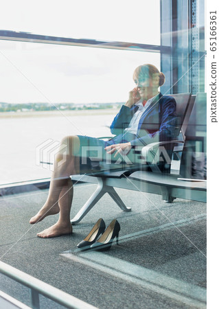 Photo of young attractive airport staff sitting 65166361