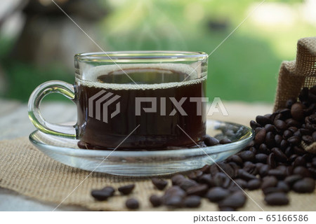 Hot Coffee cup and coffee beans roating on the Hot Coffee cup and coffee beans roating on the 65166586