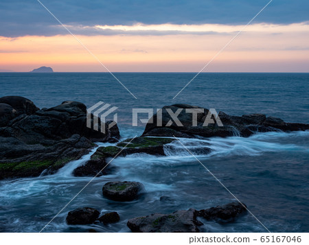 beautiful silky smooth water waves and rocks on the sea shore beautiful silky smooth water waves and rocks on the sea shore 65167046
