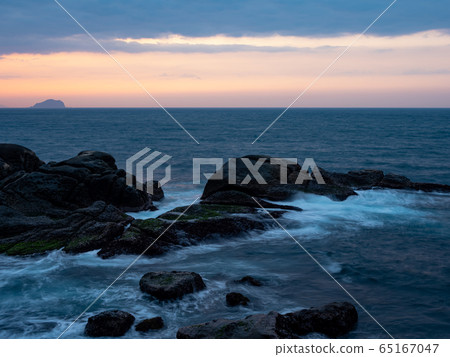 beautiful silky smooth water waves and rocks on the sea shore beautiful silky smooth water waves and rocks on the sea shore 65167047