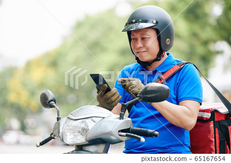 Delivery man accepting order Delivery man accepting order 65167654