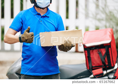 Delivery man with cardboard box Delivery man with cardboard box 65167662