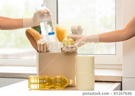 Donation box with food on a light interior background. 65167686