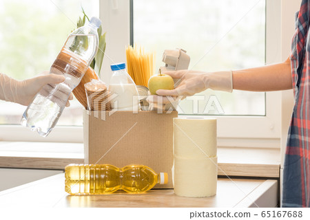 Donation box with food on a light interior background. 65167688