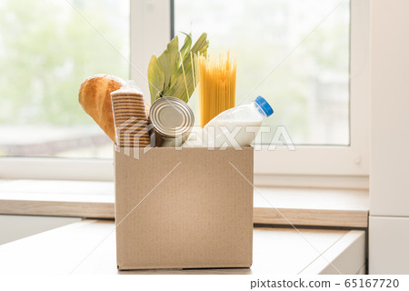 Donation box with food on a light interior background. 65167720
