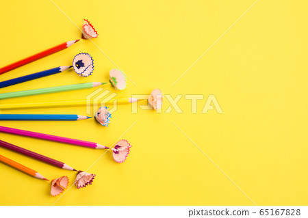 Color pencils and shavings on yellow as creative background with copyspace. Back to school concept Color pencils and shavings on yellow as creative background with copyspace. Back to school concept 65167828