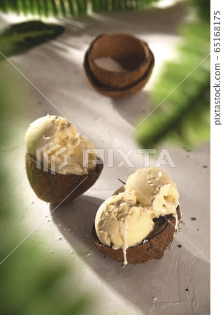 Vanilla ice cream with coconut in the sunlight with shadows. 65168175