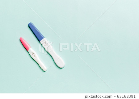 Colored Pregnancy test on colored background, top Colored Pregnancy test on colored background, top 65168391