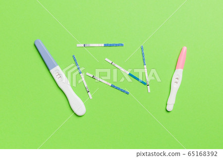 Colored Pregnancy test on colored background, top 65168392