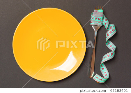 Top view of fork with measure tape near round 65168401