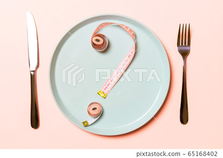 Question mark made of measuring tape on round Question mark made of measuring tape on round 65168402