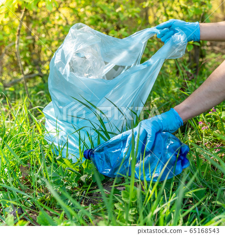 global pollution of the planet with plastic waste. Volunteers help ecology by clearing forests and meadows by collecting waste global pollution of the planet with plastic waste. Volunteers help ecology by clearing forests and meadows by collecting waste 65168543