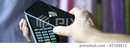 Hand holds out terminal for credit card payment Hand holds out terminal for credit card payment 65168815