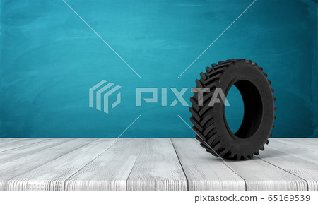3d rendering of black tractor wheel on white wooden floor and dark turquoise background 3d rendering of black tractor wheel on white wooden floor and dark turquoise background 65169539