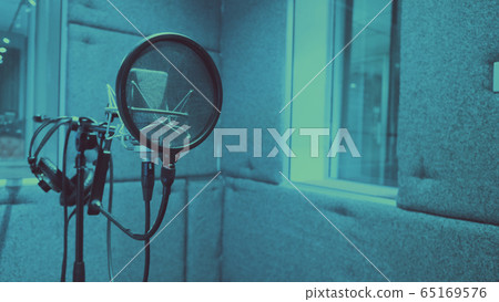 Sound production recording studio with microphone and shock mount and pop filter on tripod which use for vocalist or narrator or dj on brodcasting or professional creator live online channel Sound production recording studio with microphone and shock mount and pop filter on tripod which use for vocalist or narrator or dj on brodcasting or professional creator live online channel 65169576