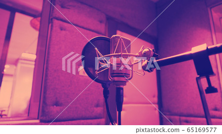 Sound production recording studio with microphone and shock mount and pop filter on tripod which use for vocalist or narrator or dj on brodcasting or professional creator live online channel Sound production recording studio with microphone and shock mount and pop filter on tripod which use for vocalist or narrator or dj on brodcasting or professional creator live online channel 65169577