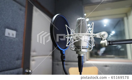 Sound production recording studio with microphone and shock mount and pop filter on tripod which use for vocalist or narrator or dj on brodcasting or professional creator live online channel Sound production recording studio with microphone and shock mount and pop filter on tripod which use for vocalist or narrator or dj on brodcasting or professional creator live online channel 65169578