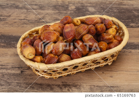 Sweet tasty dry dates in the basket 65169763