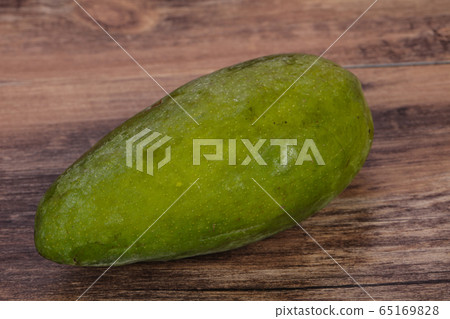 Green tasty mango over wooden background 65169828
