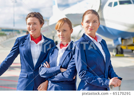 Photo of three confident flight attendants Photo of three confident flight attendants 65170291