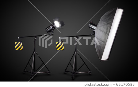 Photo studio lighting stands with flash and softbox isolated on the black. Photo studio lighting stands with flash and softbox isolated on the black. 65170583