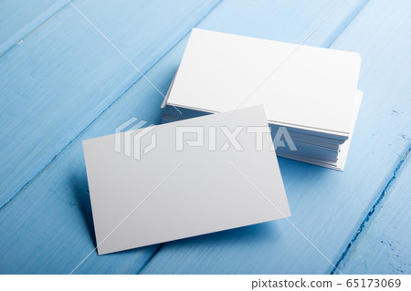 Business card blank on blue wooden background. Corporate Stationery, Branding Mock-up. Creative designer desk. Flat lay. Copy space for text 65173069