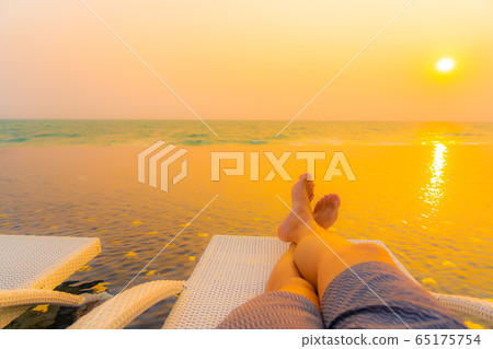 Selective focus point on leg around outdoor swimming pool in hotel resort at sunset or sunrise time Selective focus point on leg around outdoor swimming pool in hotel resort at sunset or sunrise time 65175754