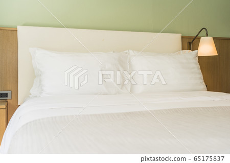 White comfortable pillow on bed decoration interior 65175837