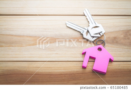 House key on a house shaped keychain concept, moving home or renting property, planning savings money of coins to buy a home concept for property, mortgage and real estate investment for a house. House key on a house shaped keychain concept, moving home or renting property, planning savings money of coins to buy a home concept for property, mortgage and real estate investment for a house. 65180485