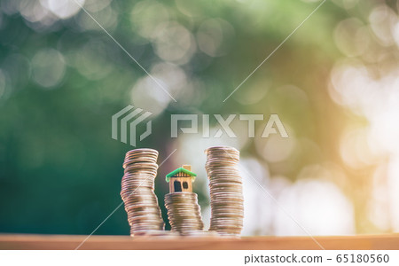 House placed on coins. planning savings money of House placed on coins. planning savings money of 65180560