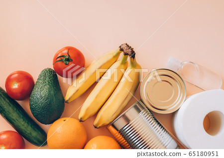 Food, toilet paper, hand sanitizer on the beige background table. Flat lay with copy space. Food, toilet paper, hand sanitizer on the beige background table. Flat lay with copy space. 65180951